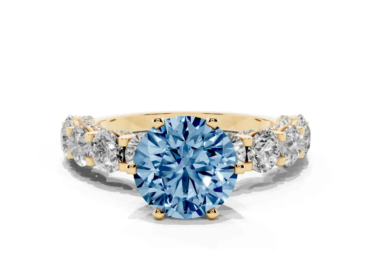 Fancy Blue Round Cut Diamond Side Stone Engagement Ring with Four-Prong Setting Yellow gold