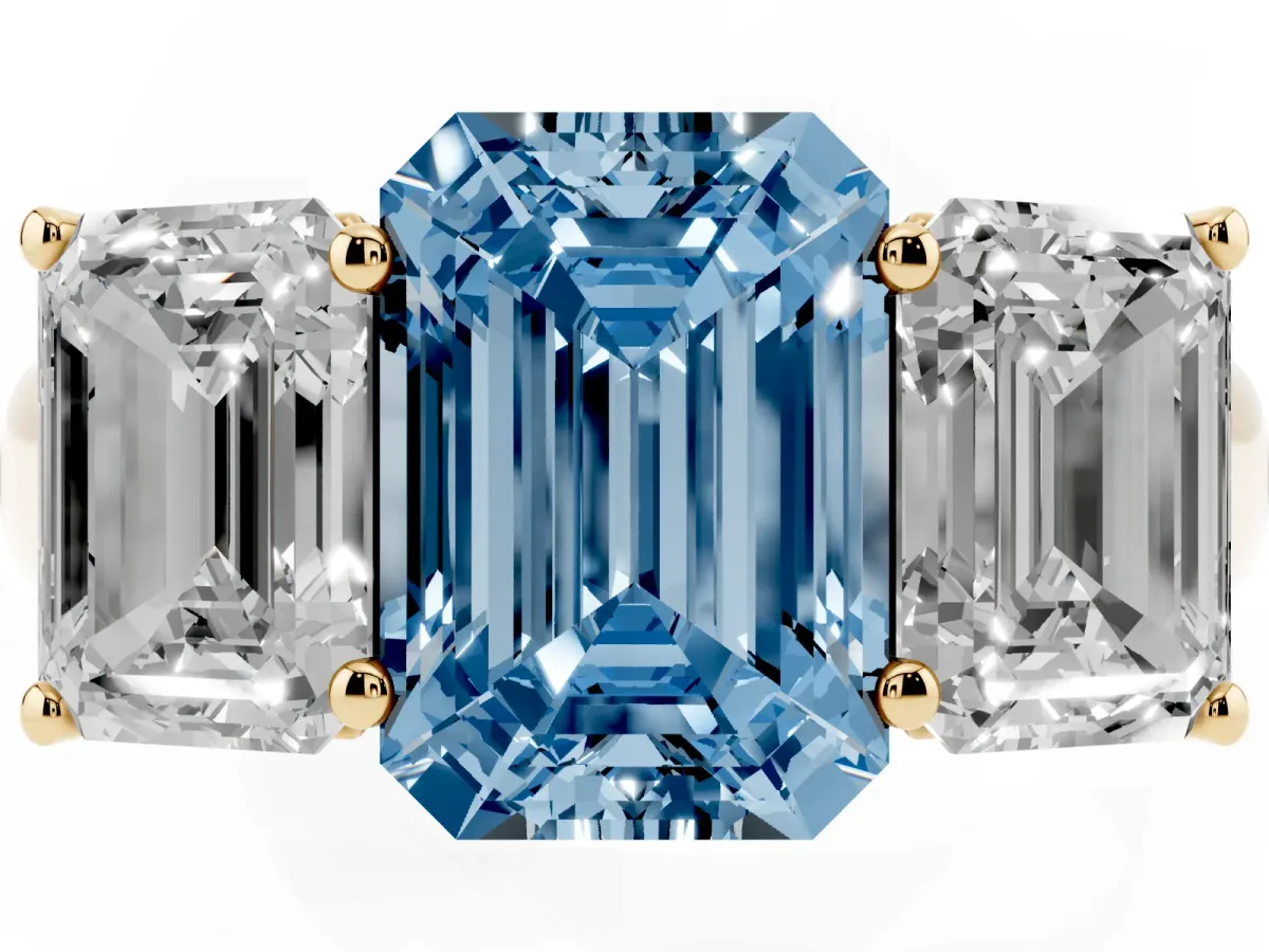 Fancy Blue Emerald Cut Three-Stone Diamond Ring with Prong Setting on a Classic Band Yellow gold