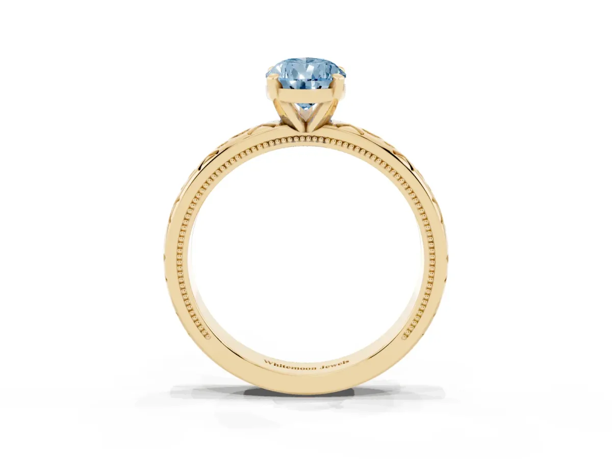 Fancy Blue Pear Cut Solitaire Engagement Ring with Scrollwork Band and Four-Prong Setting Yellow gold