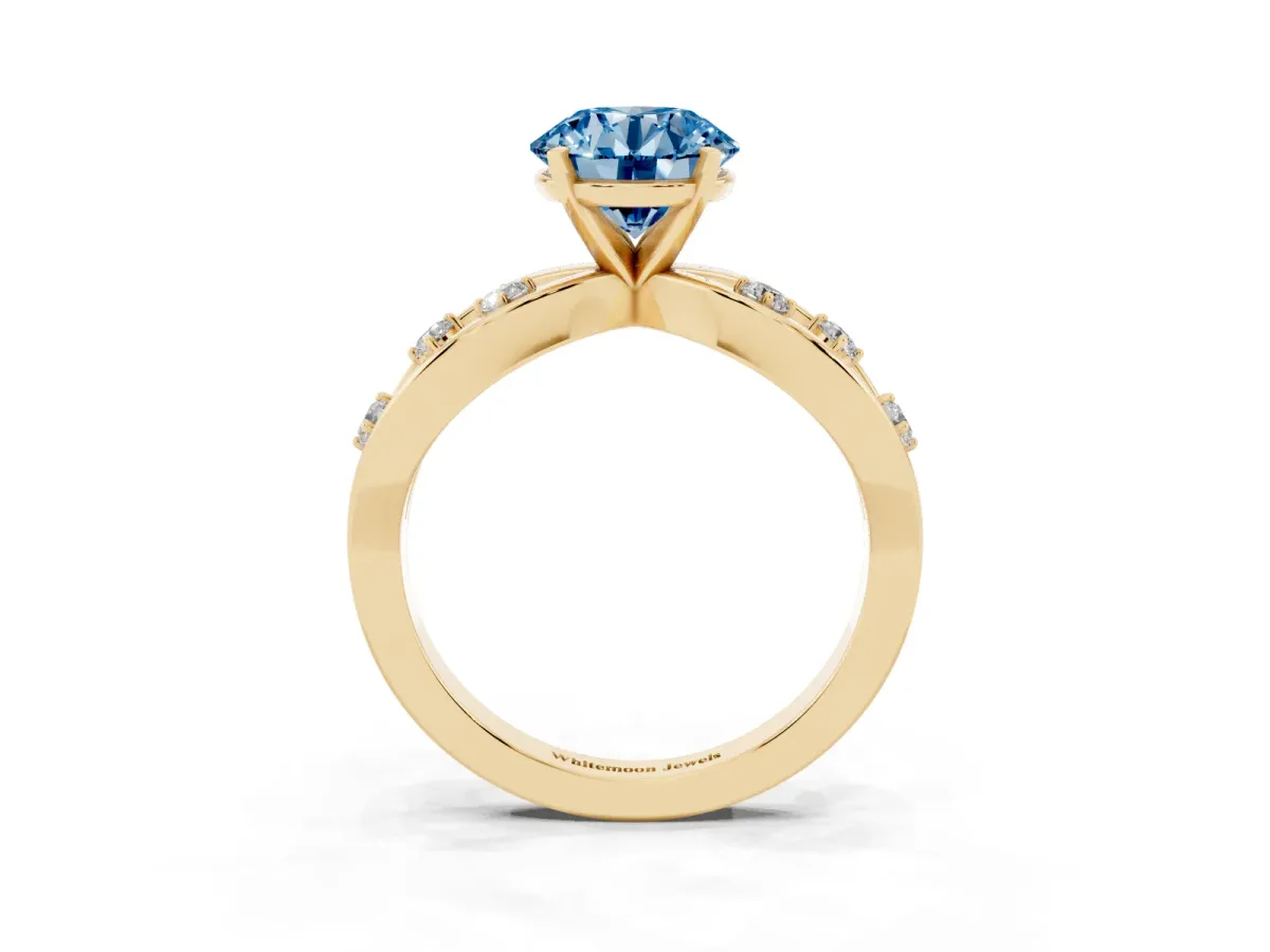 Fancy Blue Round Cut Cut Solitaire Diamond with Side Stones on Criss-Cross Band and Four-Prong Setting Yellow gold
