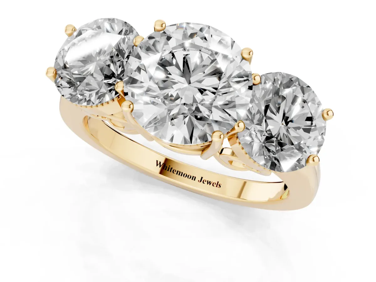 Three-Stone Round Cut Diamond Engagement Ring with Prong Setting on a Classic Band Yellow gold