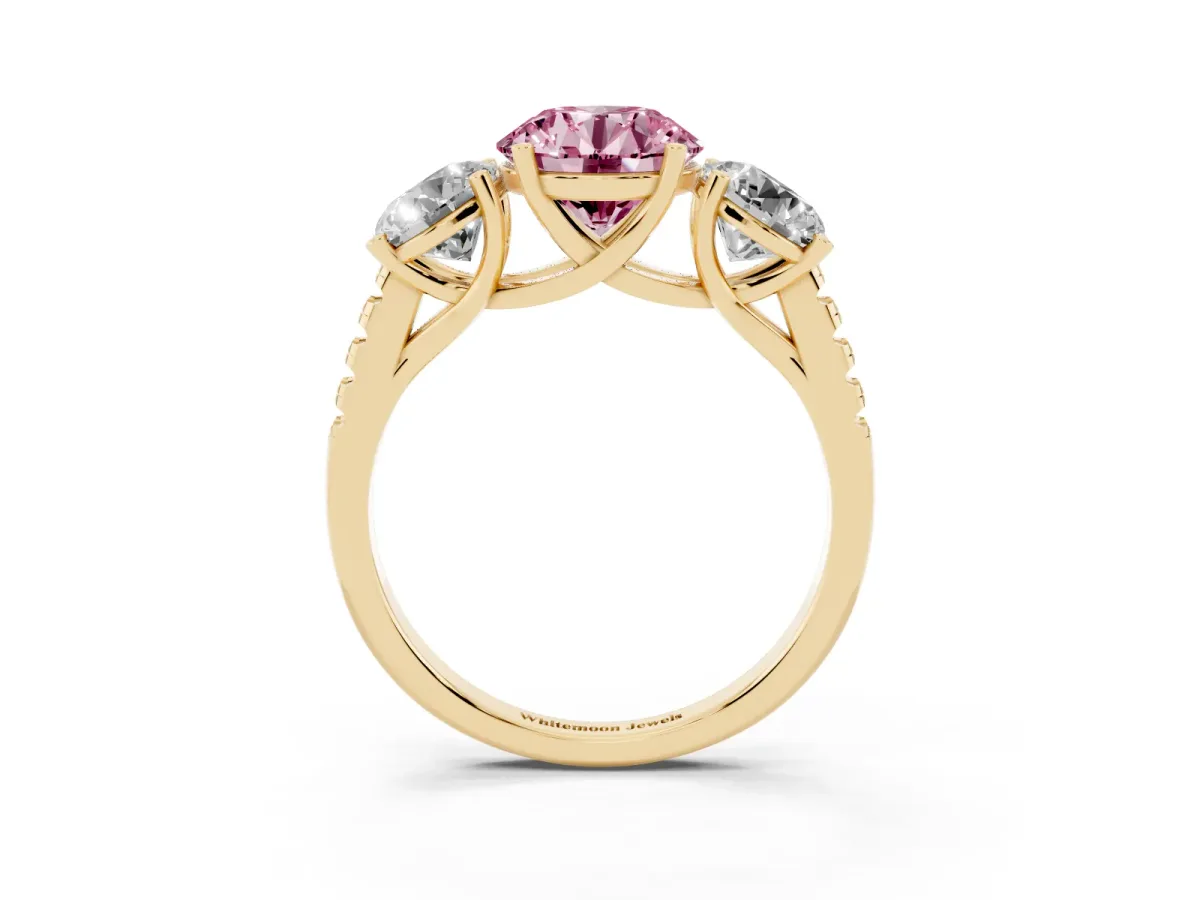 Fancy Pink Three-Stone Round Cut Diamond Ring with Round Pavé Band and Prong Setting Yellow gold