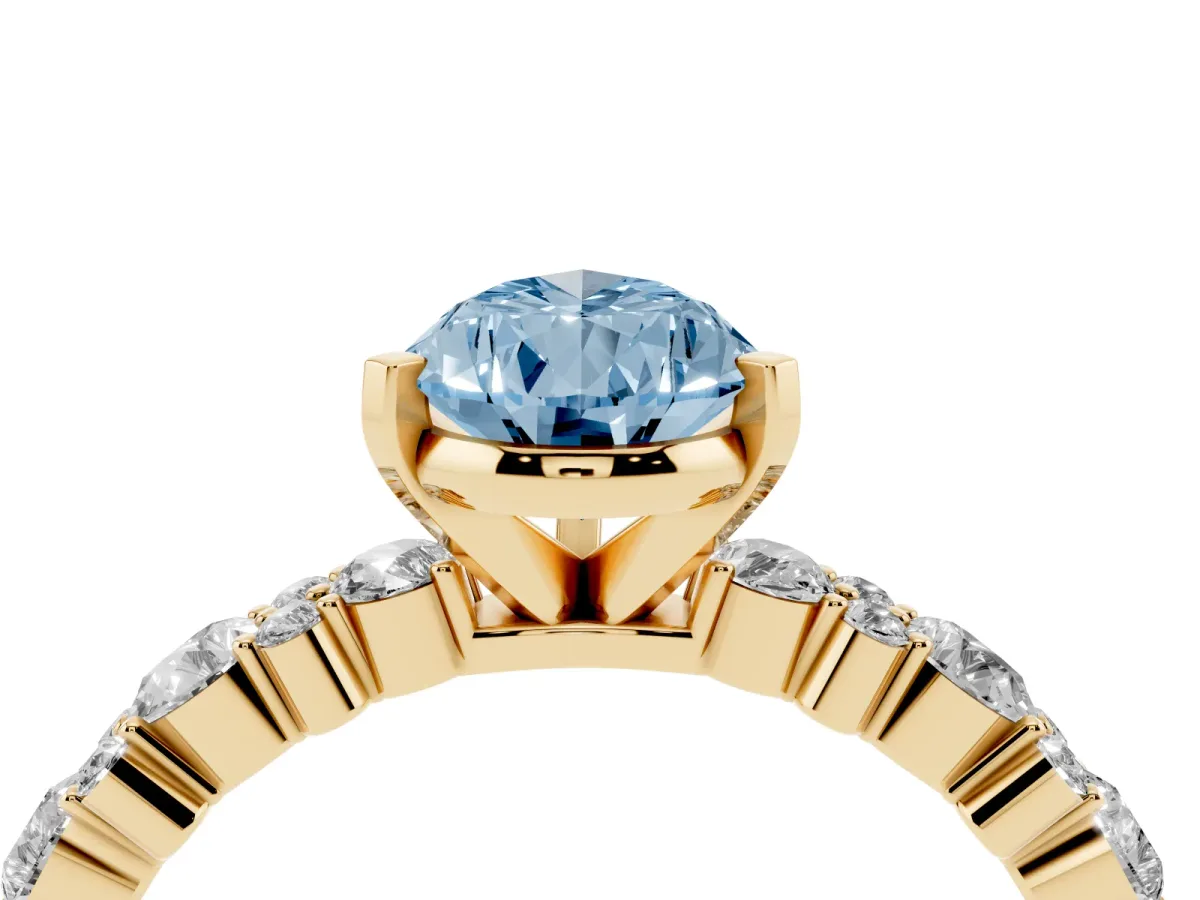 Fancy Blue Pear Cut Diamond Side Stone Solitaire Ring with Round and Four-Prong Setting Yellow gold