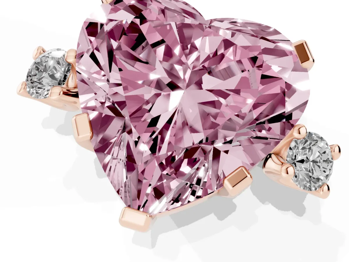 Fancy Pink Heart Cut Cut Three-Stone Solitaire Ring with Round Accent Diamonds and Four-Prong Setting Rose gold