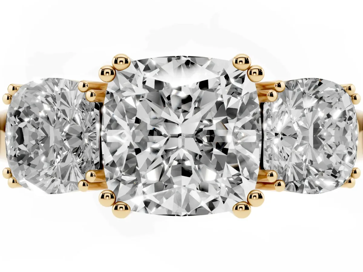Three-Stone Cushion Cut Cut Diamond Ring with Channel Set Band and Four-Prong Setting Yellow gold