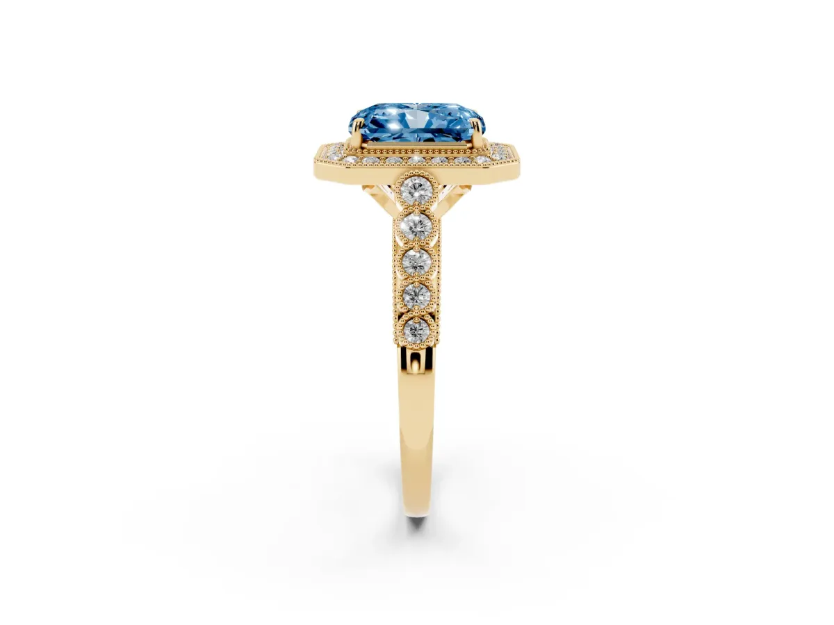Fancy Blue Radiant Cut Halo Milgrain Solitaire with Bezel Set Side Stones and Pave Band Yellow gold