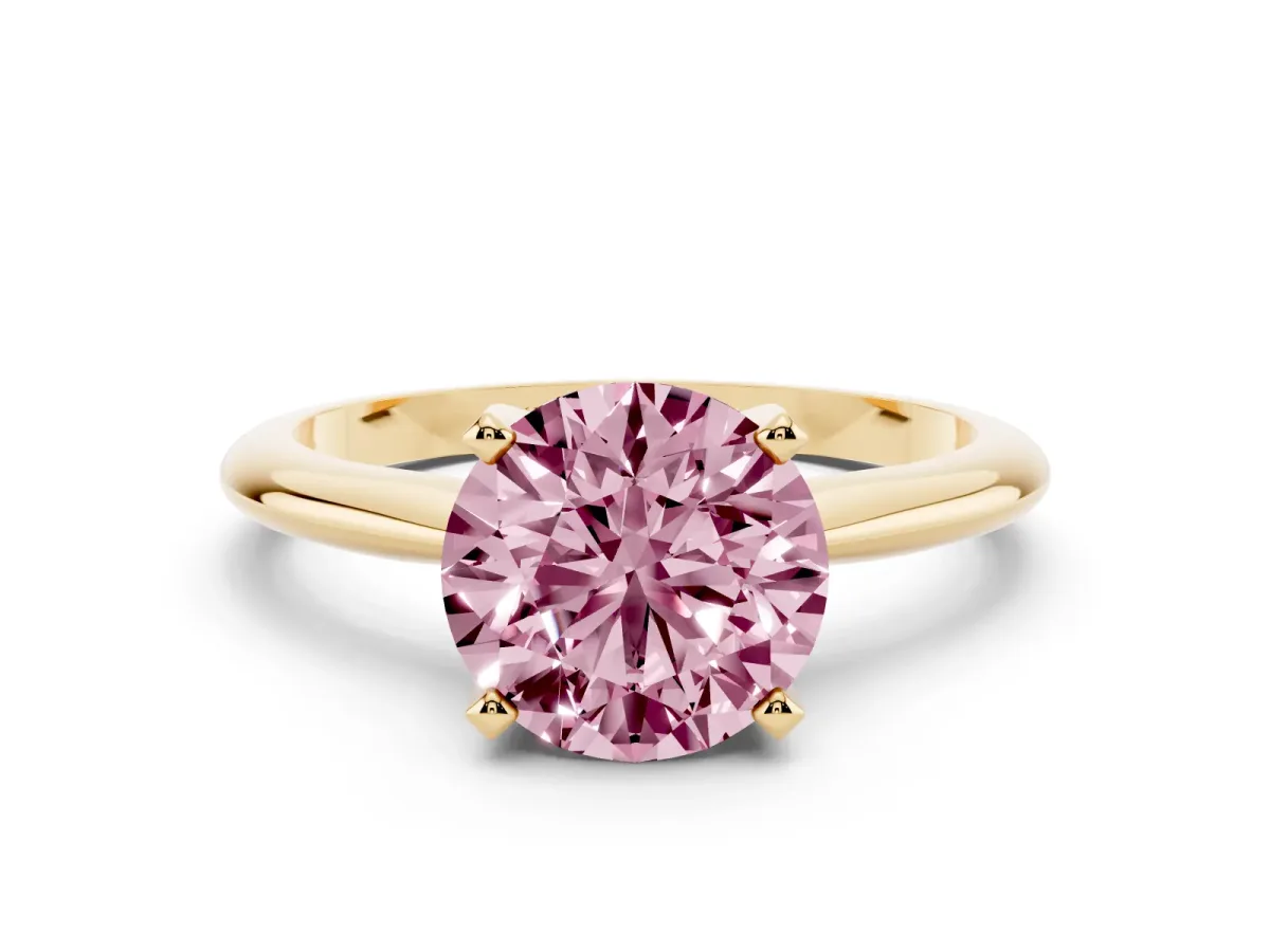 Fancy Pink Round Cut Cut Solitaire Ring with Four-Prong Setting on a Classic Band Yellow gold