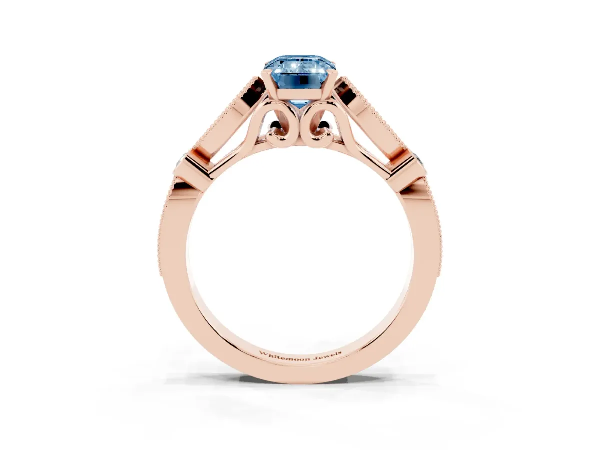 Fancy Blue Emerald Cut Cut Diamond with Milgrain Marquise and Bezel Accents on a Solitaire Band with Prong Setting Rose gold