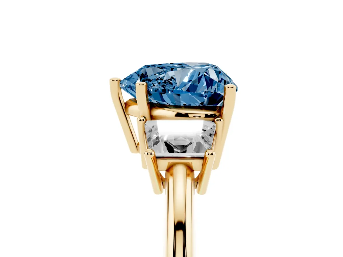 Fancy Blue Heart Cut Diamond Three-Stone Ring with Trapezoid Side Stones and Prong Setting Yellow gold