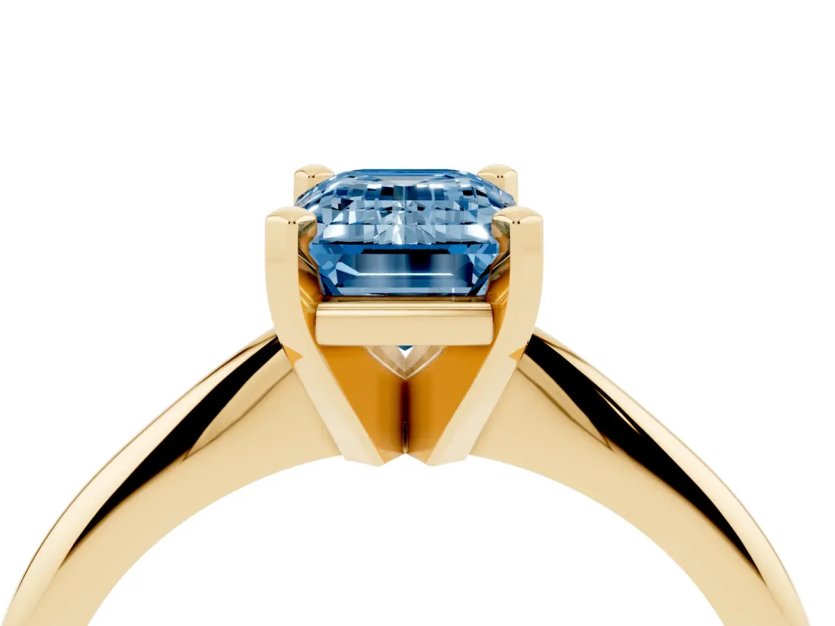 Fancy Blue Emerald Cut Cut Solitaire Ring with Four-Prong Setting on a Classic Band Yellow gold