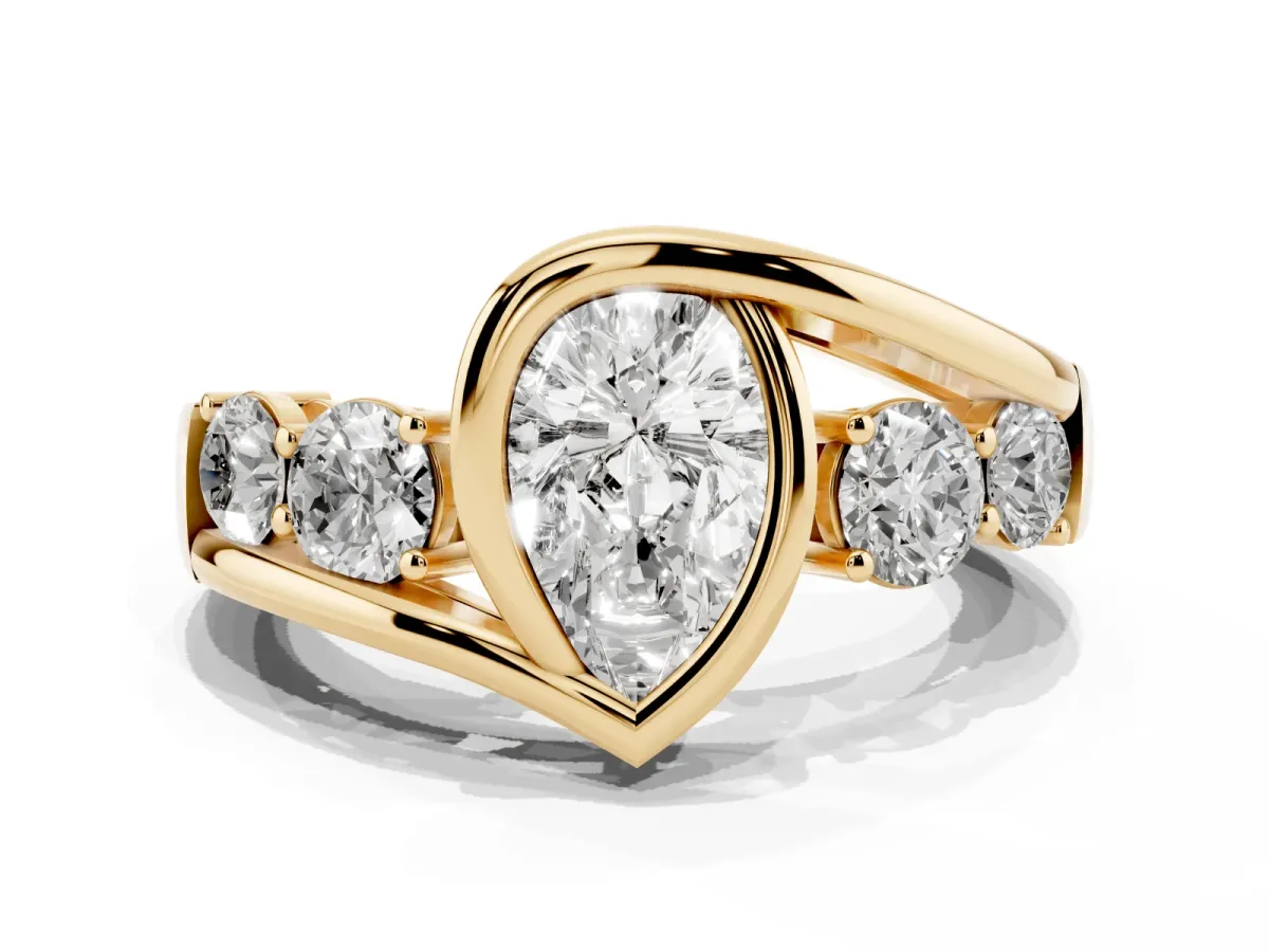 Bezel Set Pear Cut Diamond Bypass Ring with Round Accents Yellow gold