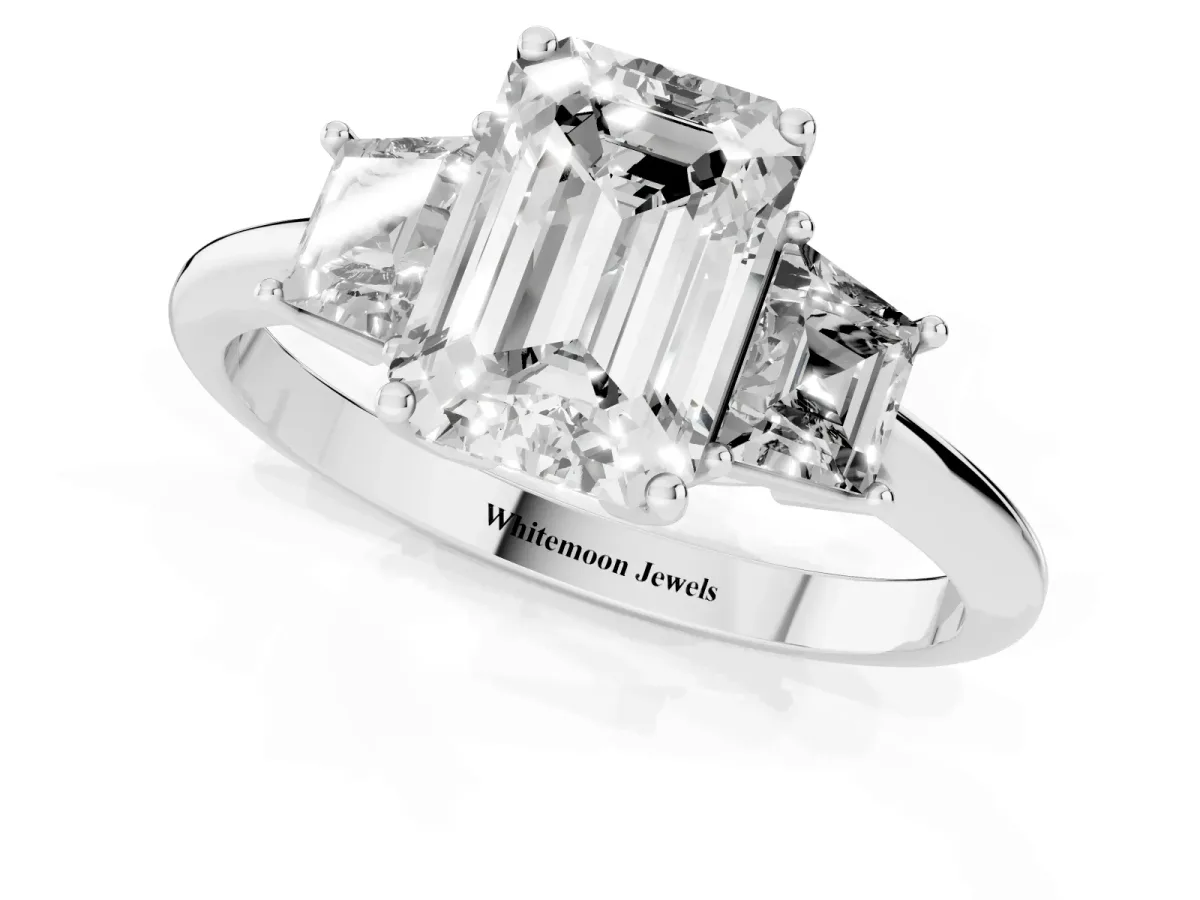 Emerald Cut Diamond Three-Stone Ring with Trapezoid Side Stones and Prong Setting Silver