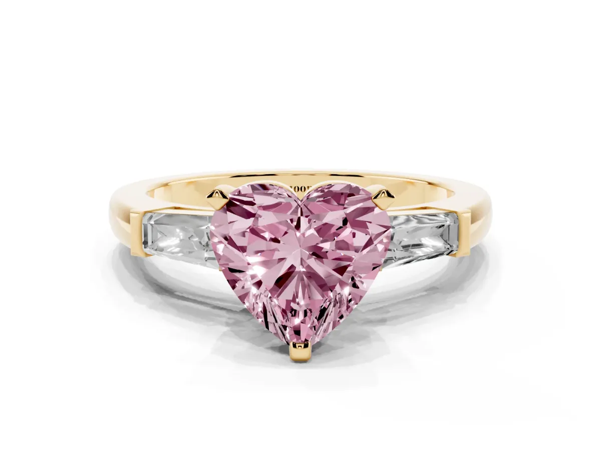 Fancy Pink Heart Cut Solitaire with Tapered Baguette Side Stones on a Classic Band with Four-Prong Setting Yellow gold
