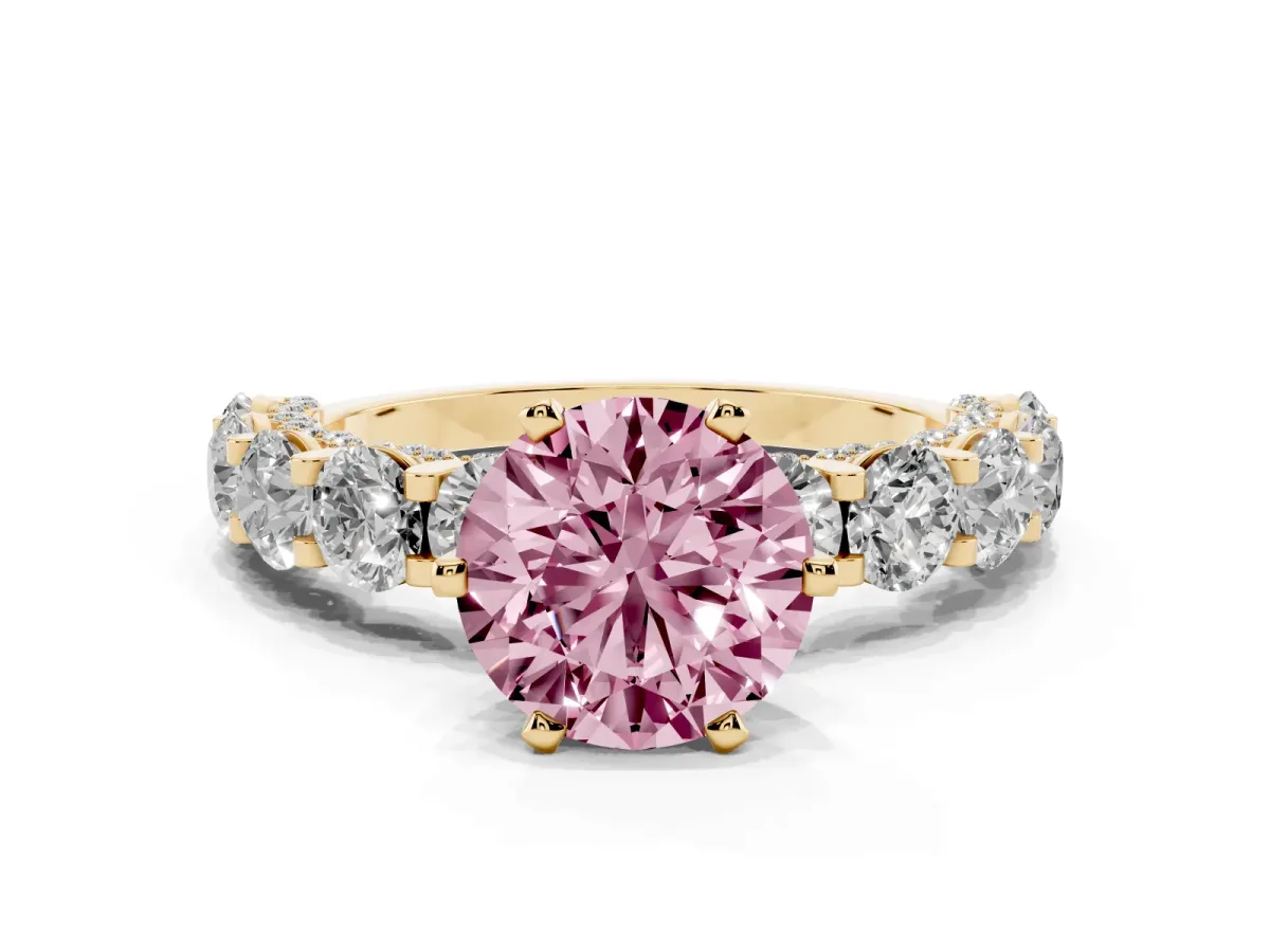 Fancy Pink Round Cut Diamond Side Stone Engagement Ring with Four-Prong Setting Yellow gold