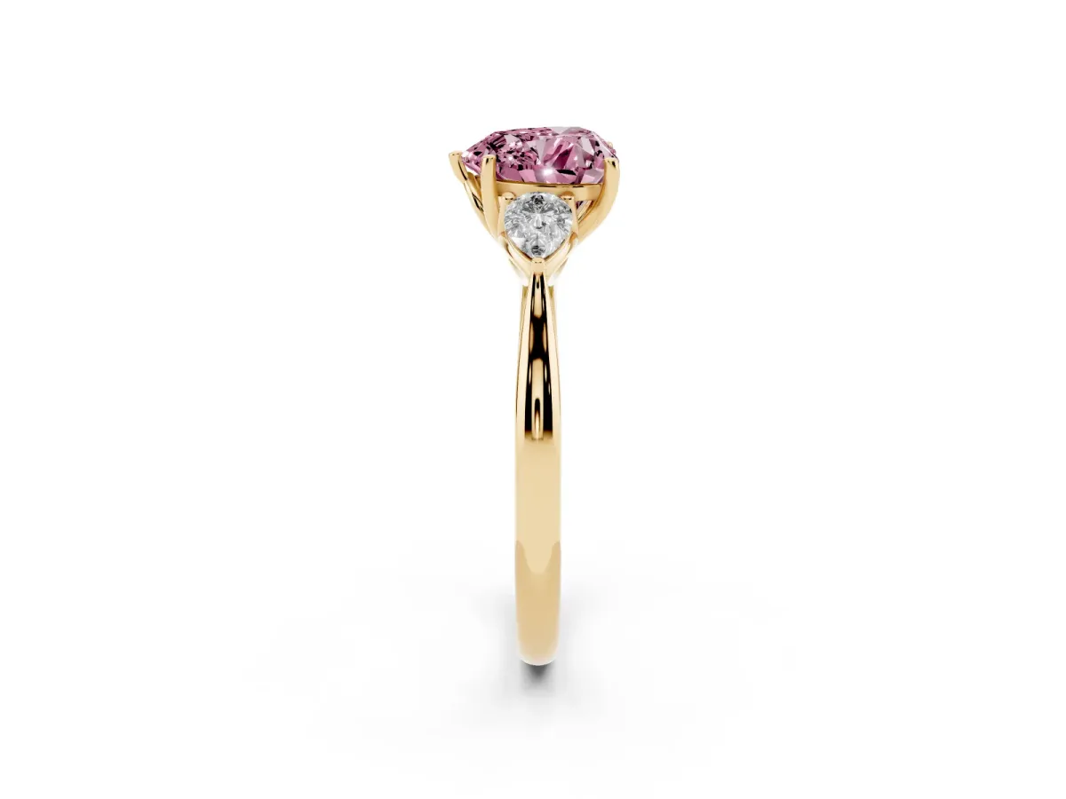 Fancy Pink Three-Stone Heart Cut Diamond Ring with Pear Side Stones in Four-Prong Setting Yellow gold