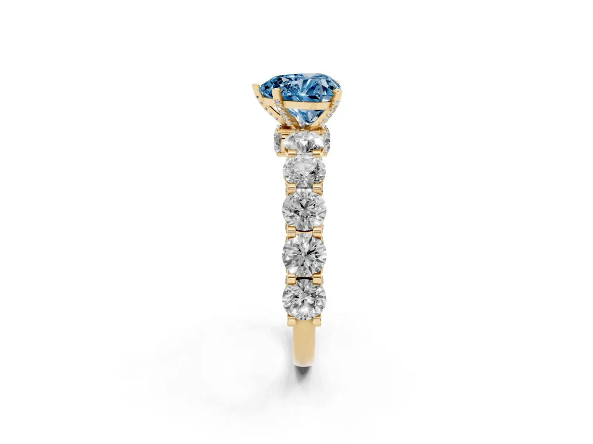 Fancy Blue Heart Cut Diamond Side Stone Engagement Ring with Four-Prong Setting Yellow gold