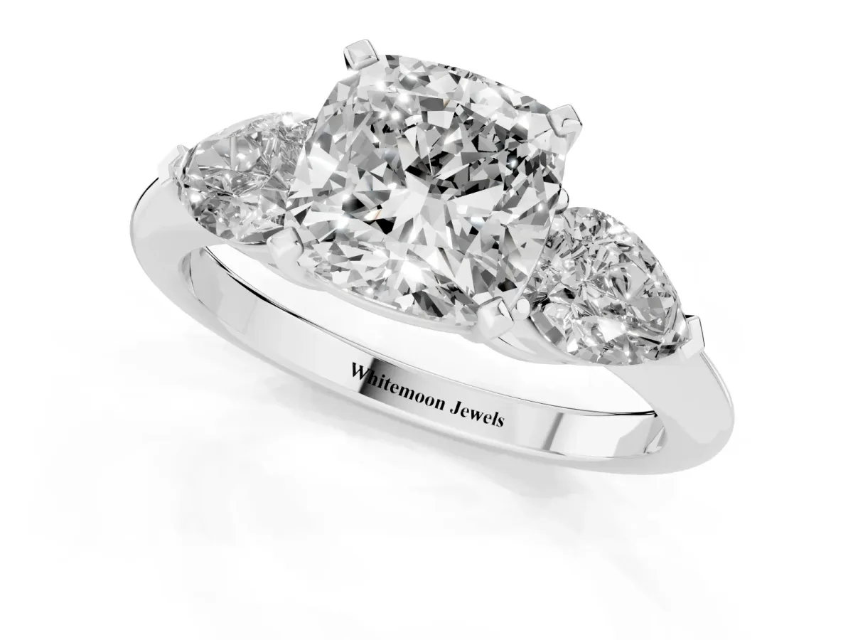 Three-Stone Cushion Cut Diamond Ring with Pear Side Stones and Four-Prong Setting Platinum
