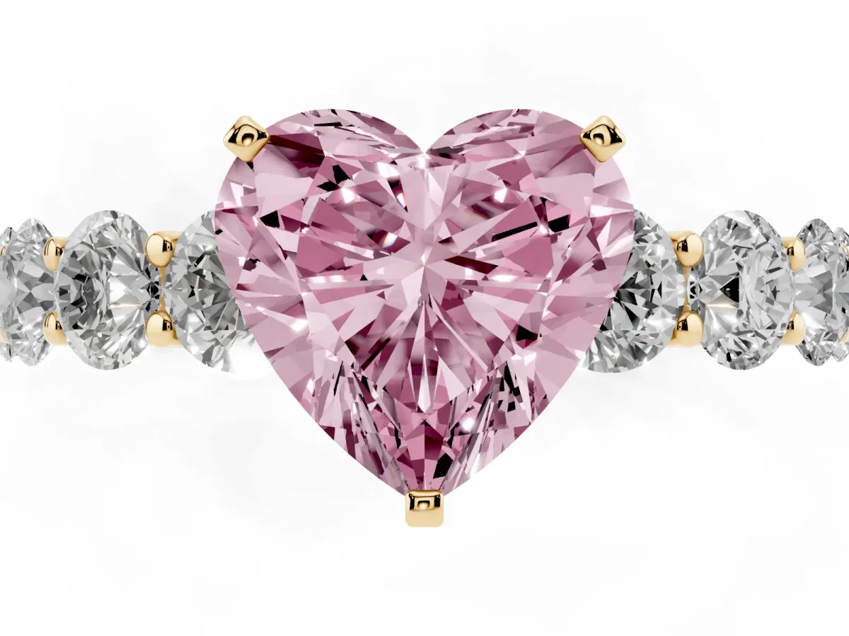Fancy Pink Heart Cut Diamond Prong Setting with Side Stones on a Pave Band Yellow gold