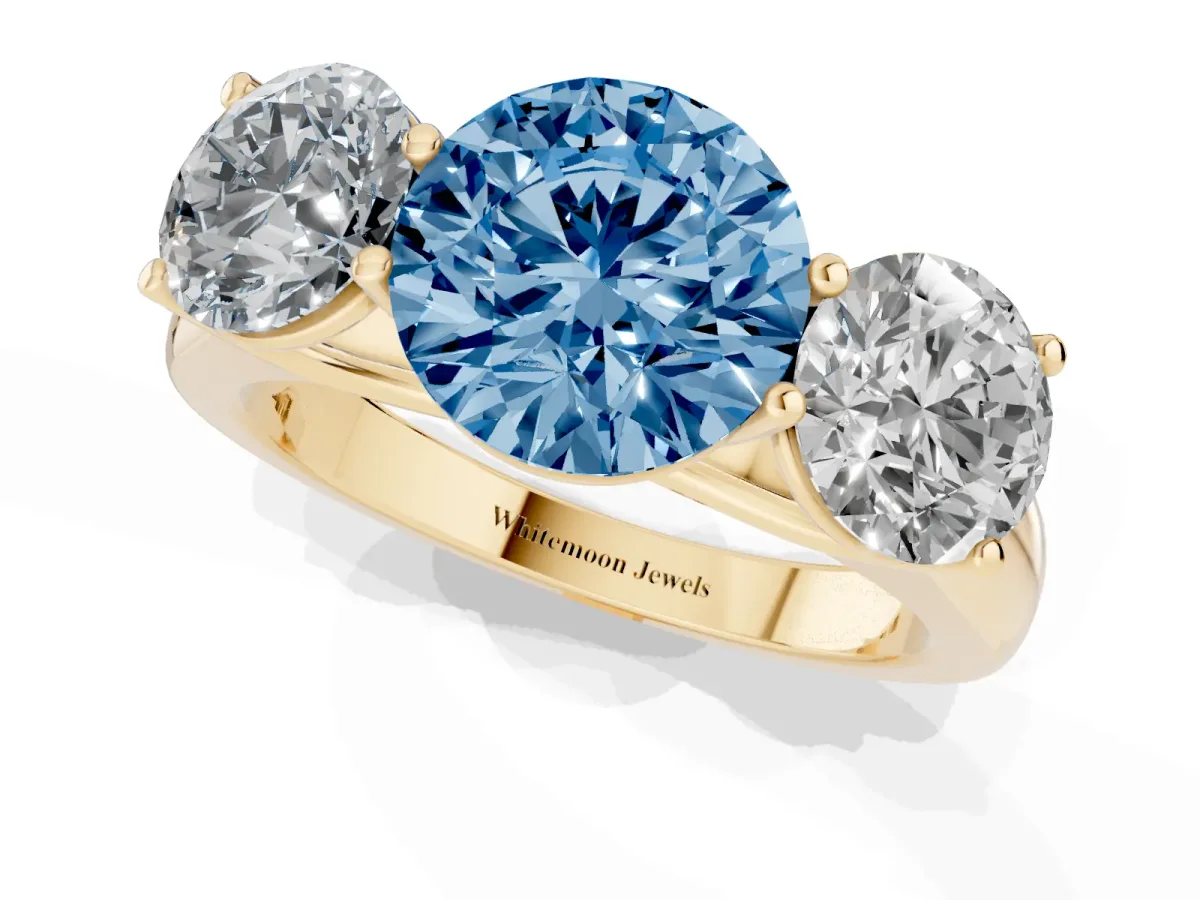 Fancy Blue Round Cut Three-Stone Diamond Ring with Prong Setting on a Classic Band Yellow gold