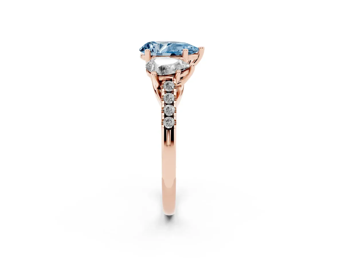 Fancy Blue Three-Stone Pear Cut Diamond Ring with Round Pavé Band and Prong Setting Rose gold