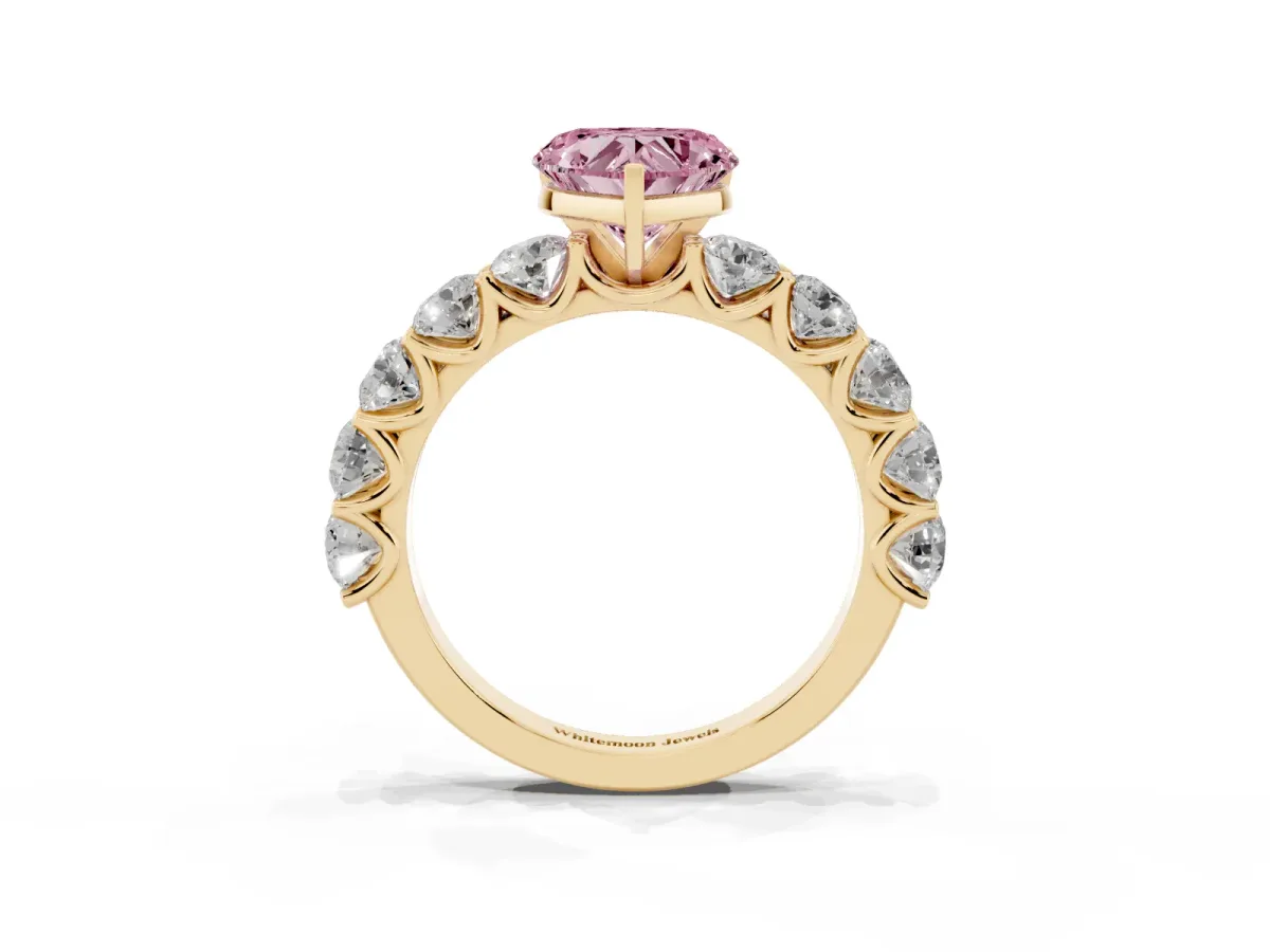 Fancy Pink Heart Cut Diamond Prong Setting with Side Stones on a Pave Band Yellow gold