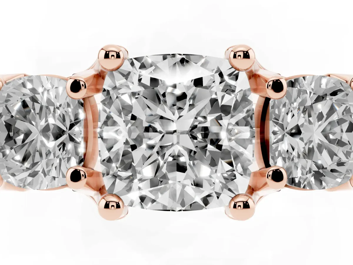 Cushion Cut Diamond Three-Stone Ring with Channel Set Band and Four-Prong Setting Rose gold