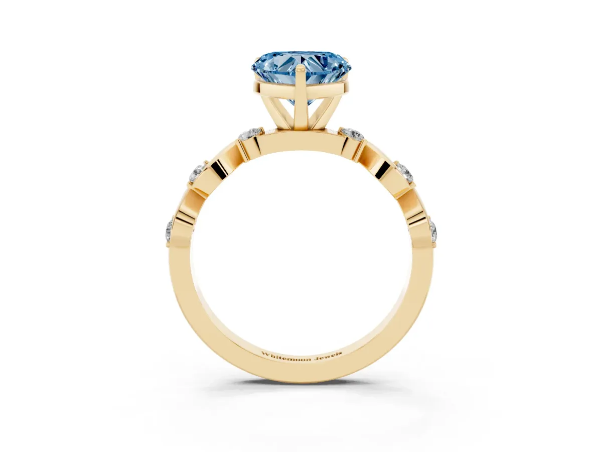 Fancy Blue Heart Cut Diamond Solitaire Twisted Band with Round Accents and Prong Setting Yellow gold