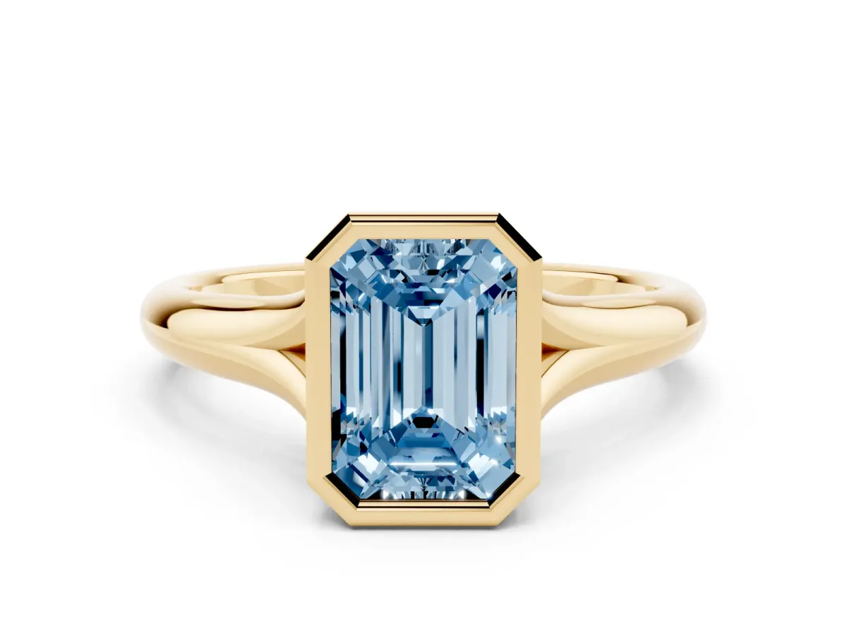 Fancy Blue Bezel Set Emerald Cut Solitaire Diamond Ring with Smooth Band Yellow gold