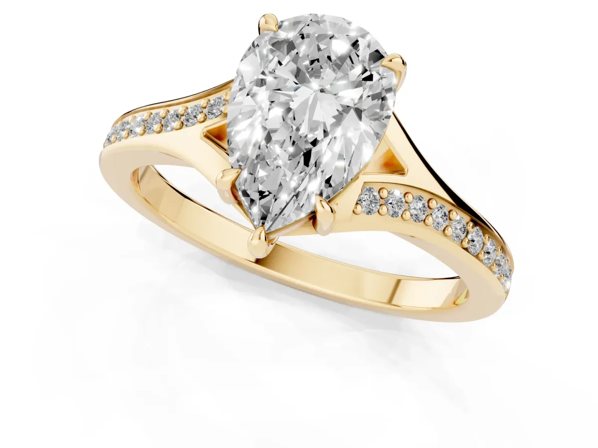 Pear Cut Diamond Solitaire Ring with Pavé Band and Prong Setting Yellow gold