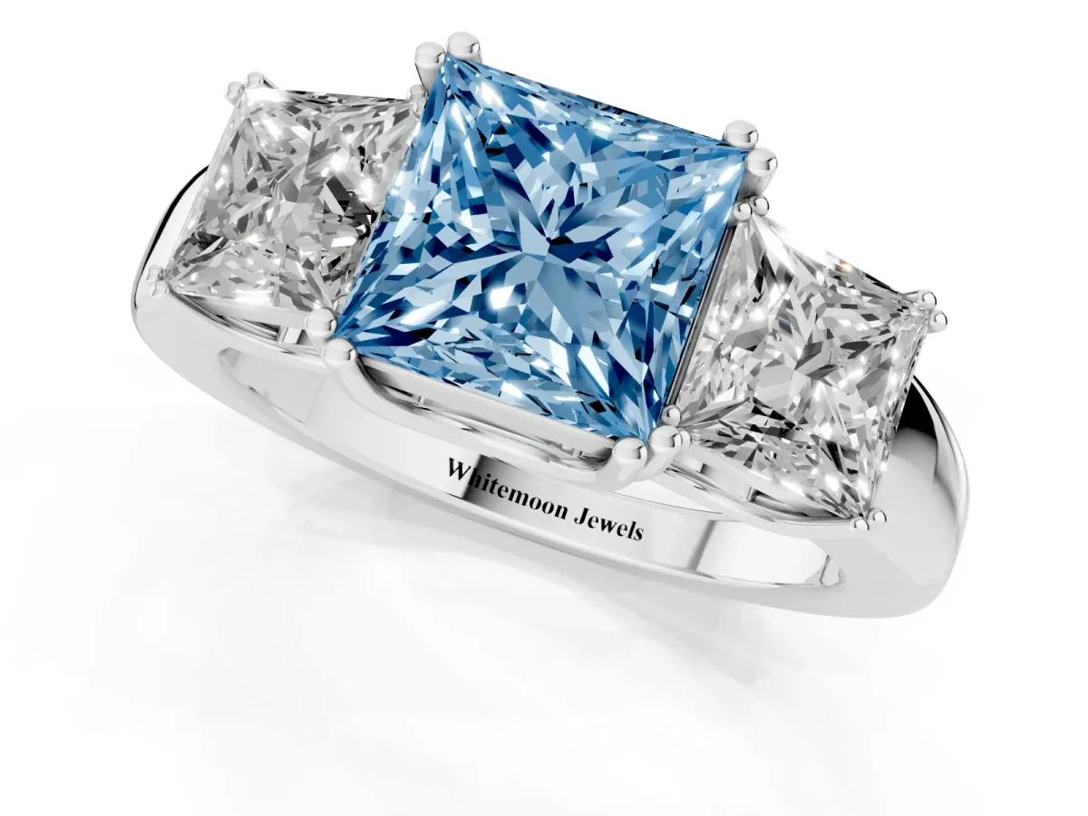 Fancy Blue Three-Stone Princess Cut Cut Diamond Ring with Channel Set Band and Four-Prong Setting Platinum