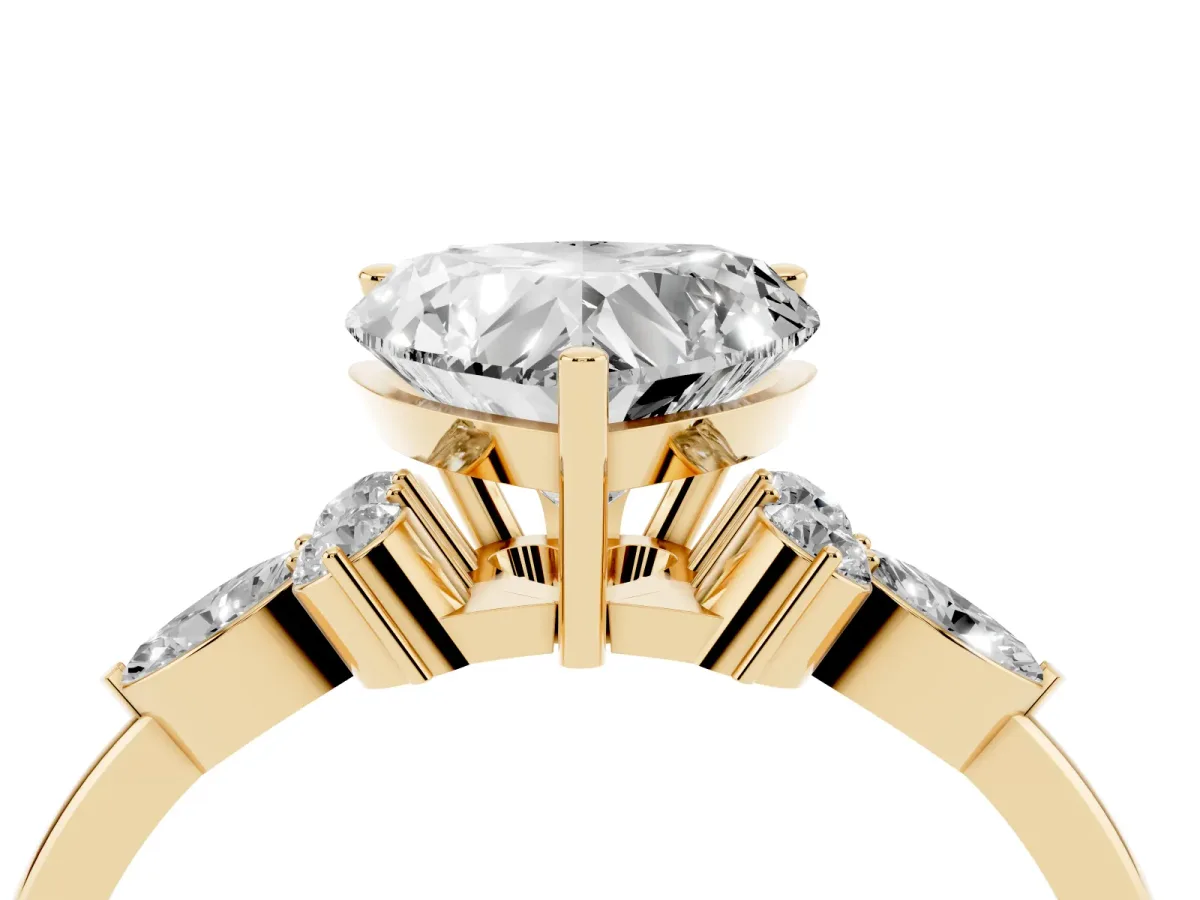 Heart Cut Brilliant Diamond Solitaire Ring with Pear Side Stones and Four-Prong Setting Yellow gold