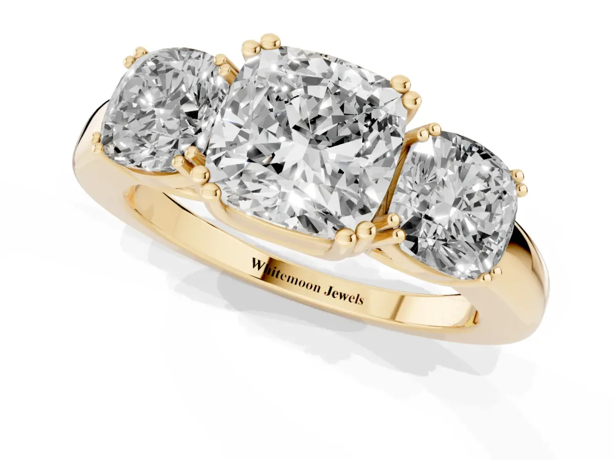 Three-Stone Cushion Cut Cut Diamond Ring with Channel Set Band and Four-Prong Setting Yellow gold