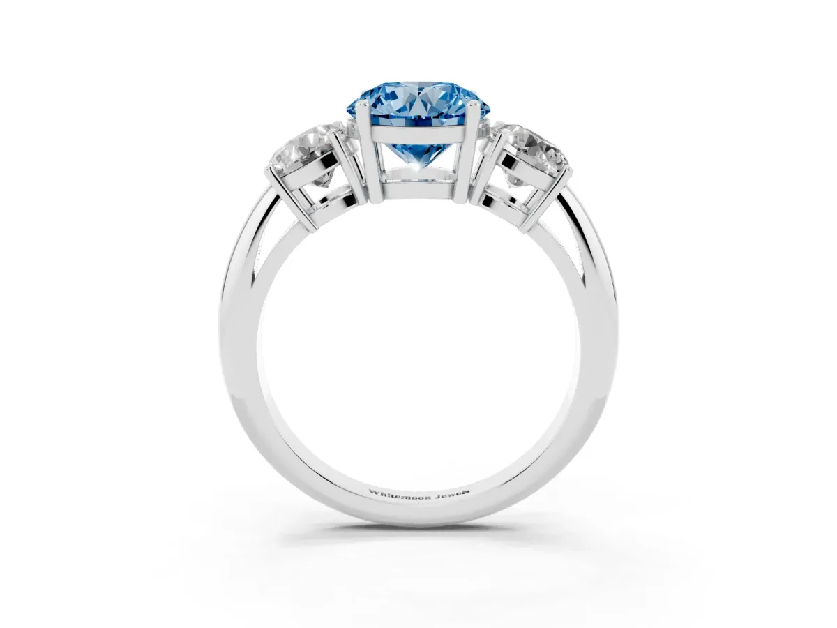 Fancy Blue Three-Stone Round Cut Cut Diamond Engagement Ring with Prong Setting on a White Gold Band Platinum