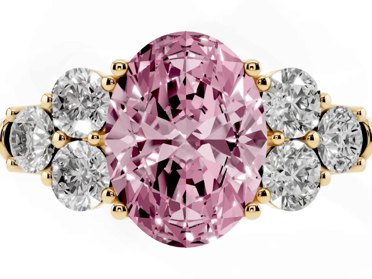 Fancy Pink Oval Cut Cut Diamond Cluster Ring with Round Accent Stones and Prong Setting on a Classic Band Yellow gold