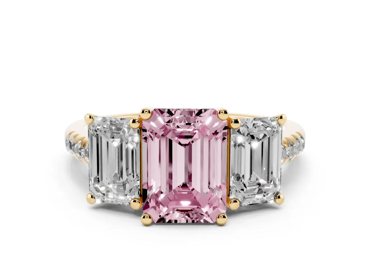 Fancy Pink Three-Stone Emerald Cut Diamond Ring with Round Pavé Band and Prong Setting Yellow gold