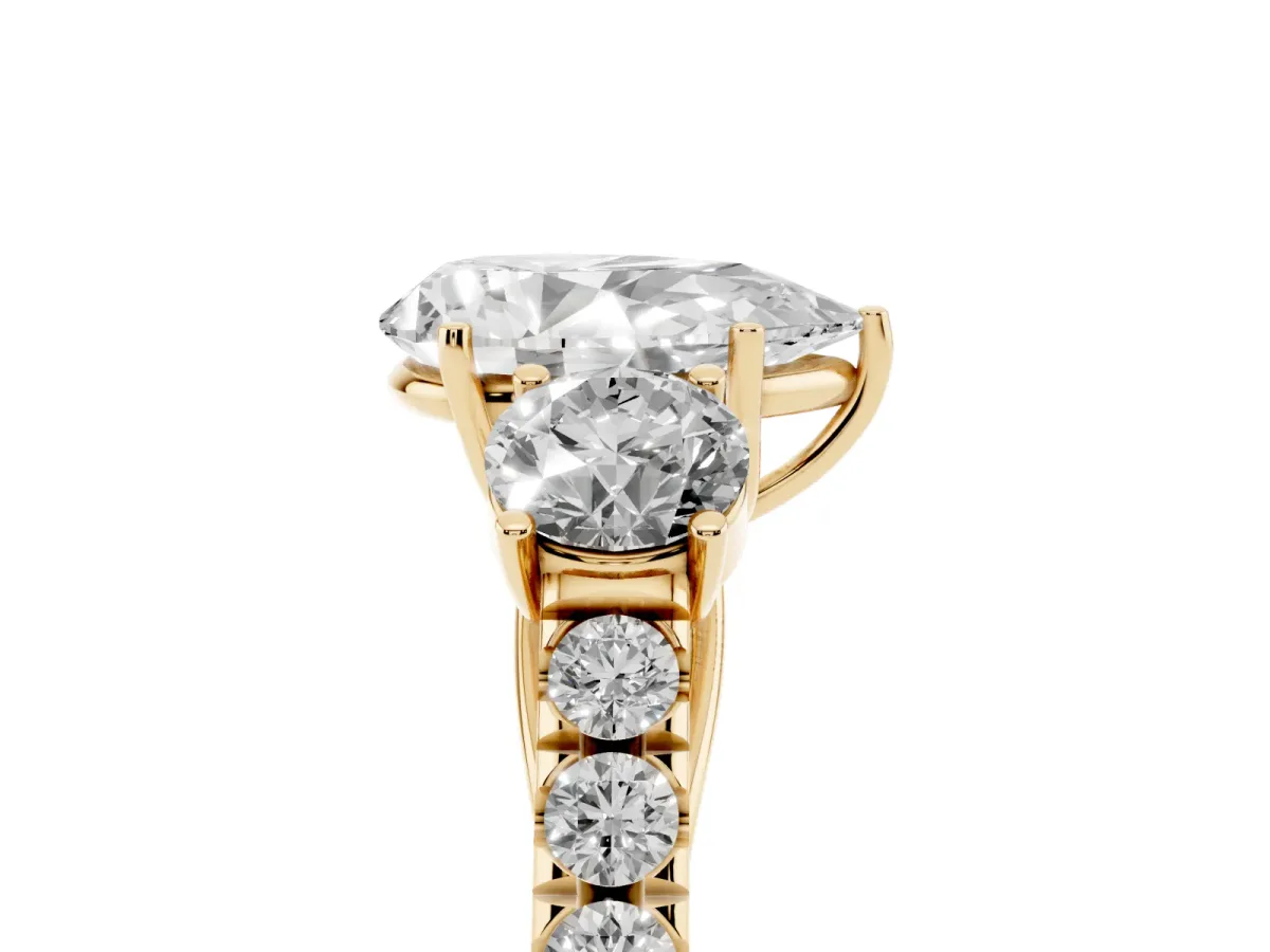 Pear Cut Cut Diamond Three-Stone Ring with Round Side Stones and Pavé Band Yellow gold