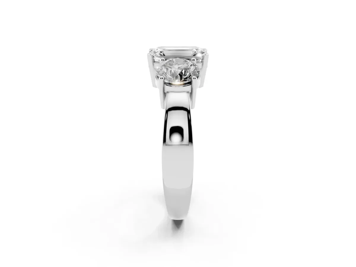 Three-Stone Emerald Cut Diamond Ring with Round Side Stones, Classic Band, and Four-Prong Setting Silver