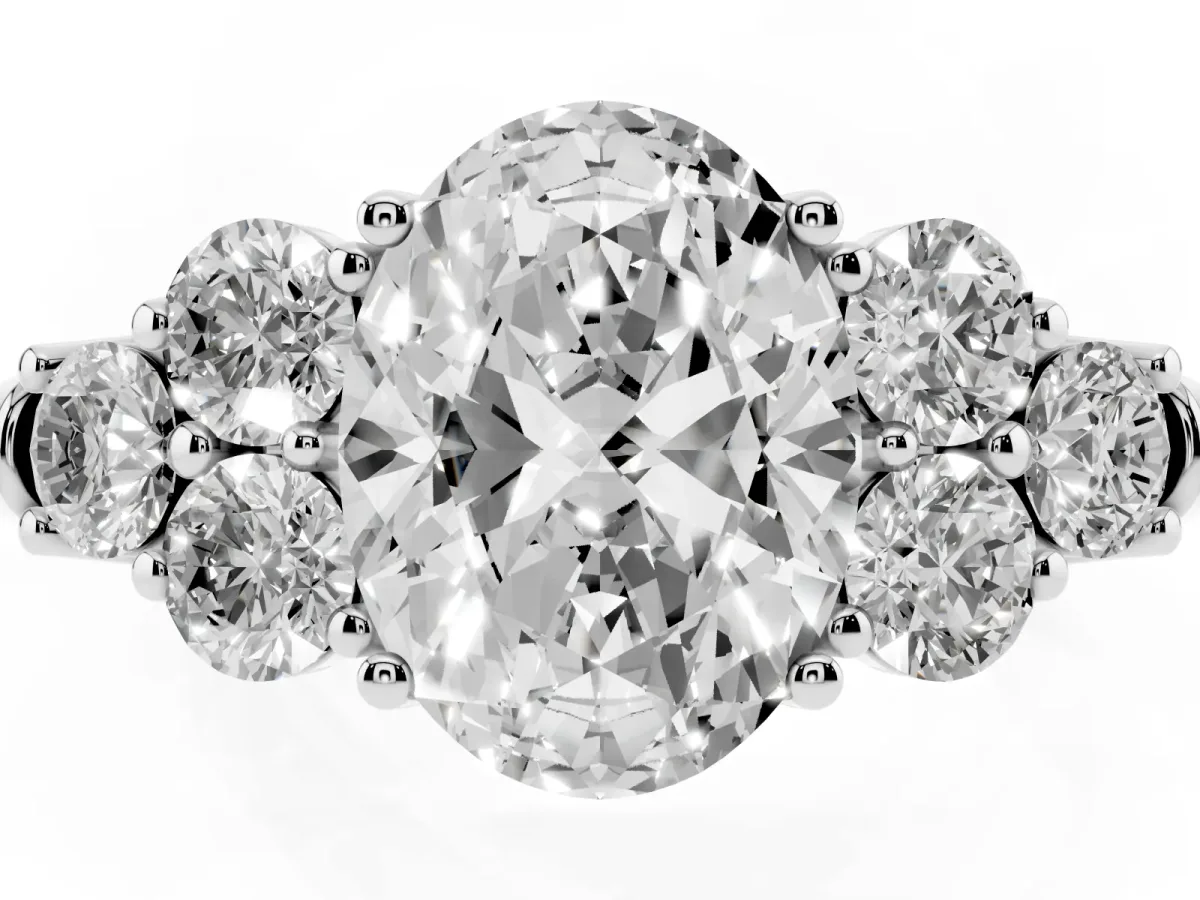 Oval Cut Cut Diamond Cluster Ring with Round Accent Stones and Prong Setting on a Classic Band White gold