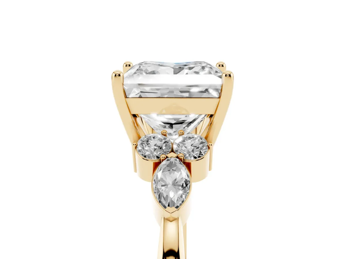 Princess Cut Brilliant Diamond Solitaire Ring with Pear Side Stones and Four-Prong Setting Yellow gold