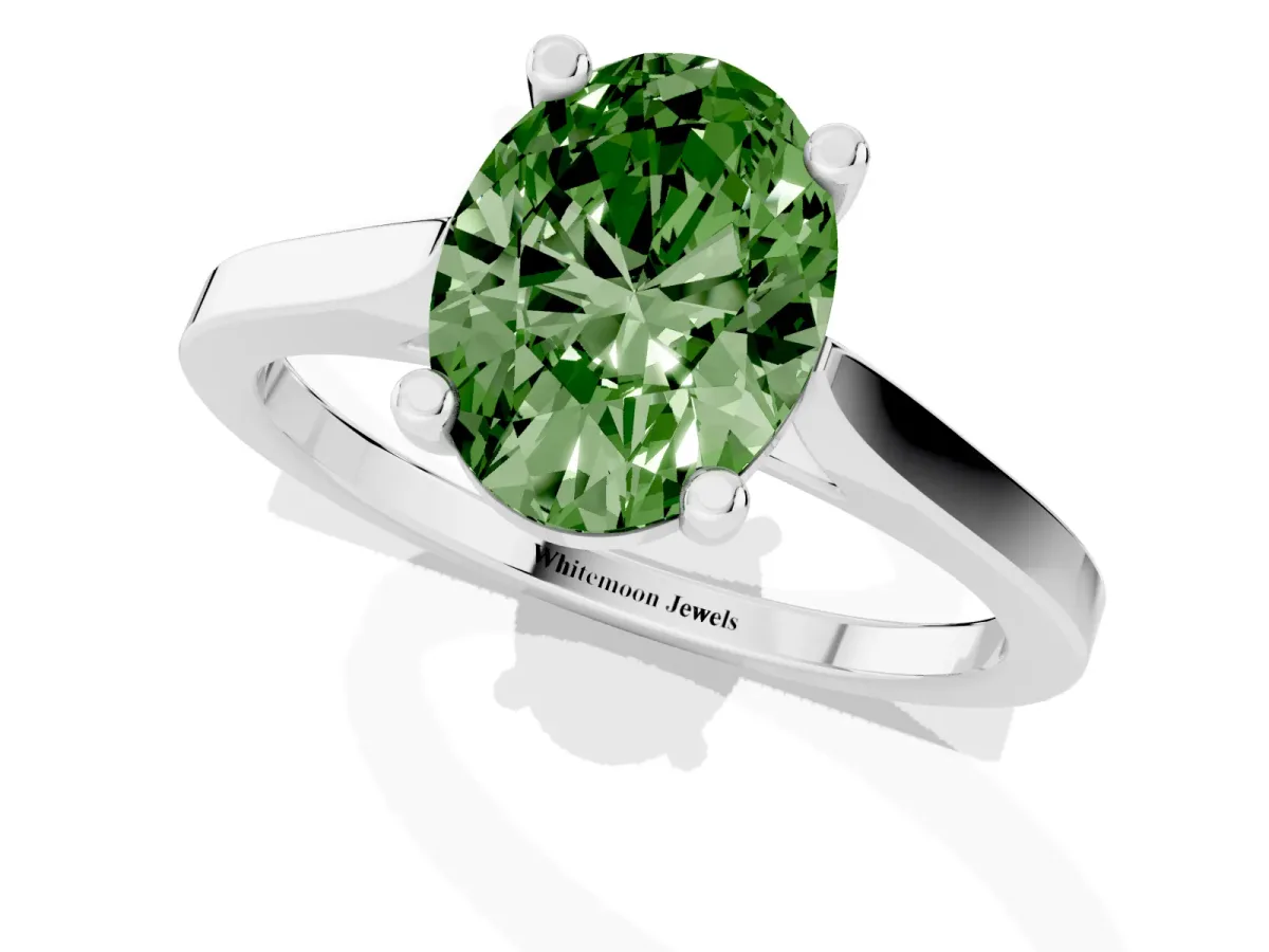 Fancy Green Oval Cut Solitaire Diamond Ring with Four-Prong Setting and Tapered Band Platinum