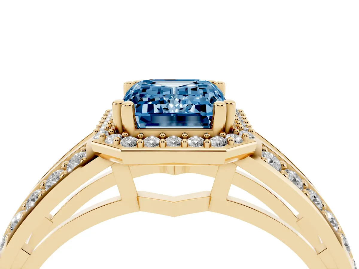 Fancy Blue Emerald Cut Diamond Halo Ring with Split Shank Pavé Band and Four-Prong Setting Yellow gold
