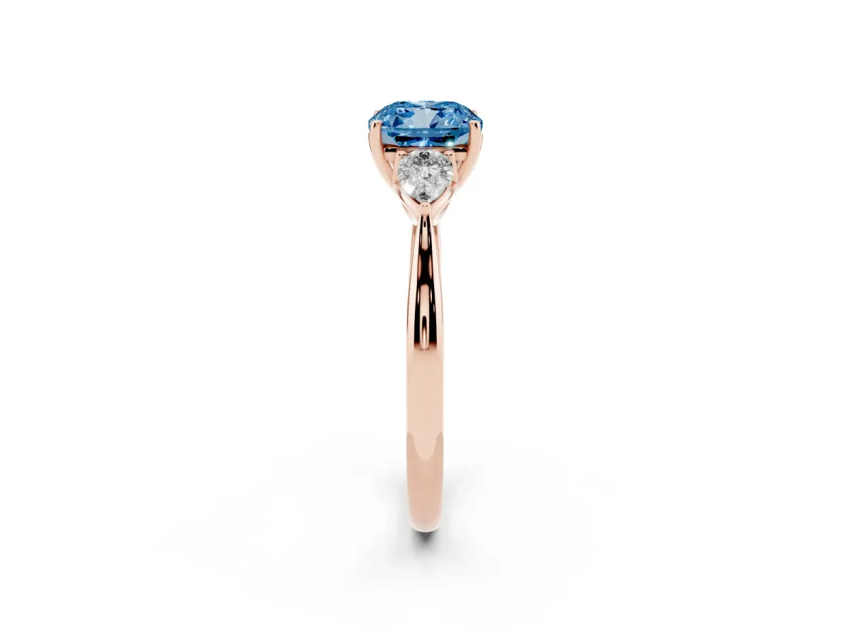 Fancy Blue Three-Stone Cushion Cut Diamond Ring with Pear Side Stones in Four-Prong Setting Rose gold