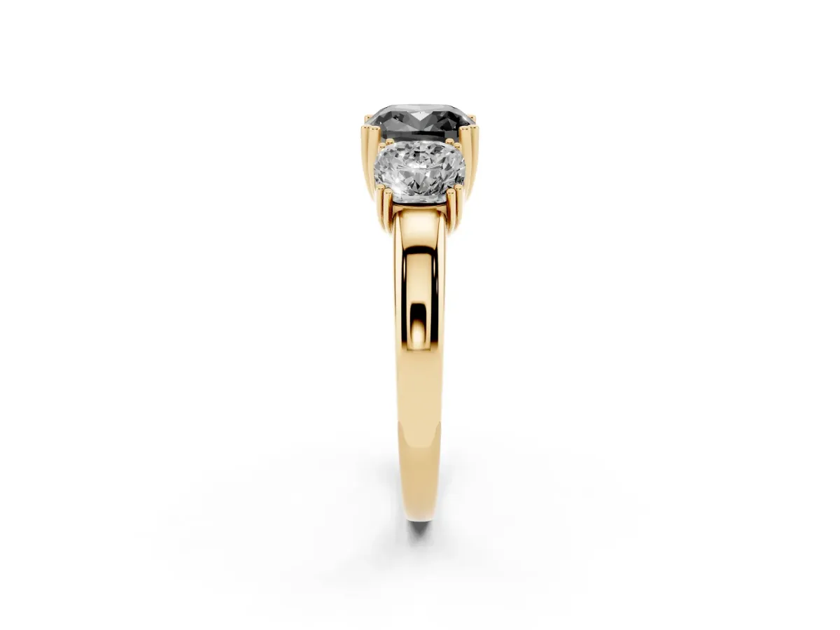 Fancy Black Three-Stone Cushion Cut Cut Diamond Ring with Channel Set Band and Four-Prong Setting Yellow gold