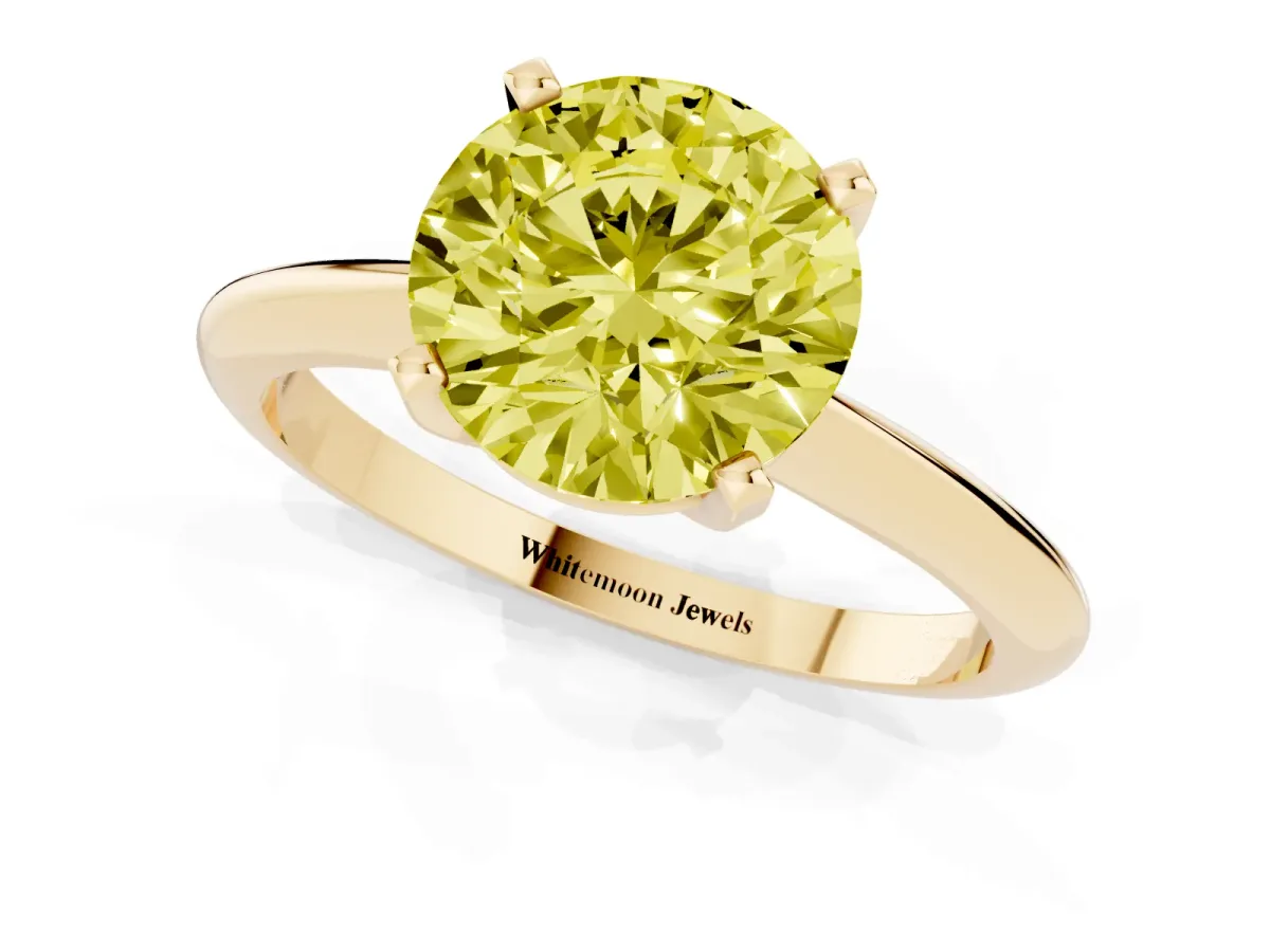 Fancy Yellow Round Cut Cut Solitaire Ring with Four-Prong Setting on a Classic Band Yellow gold
