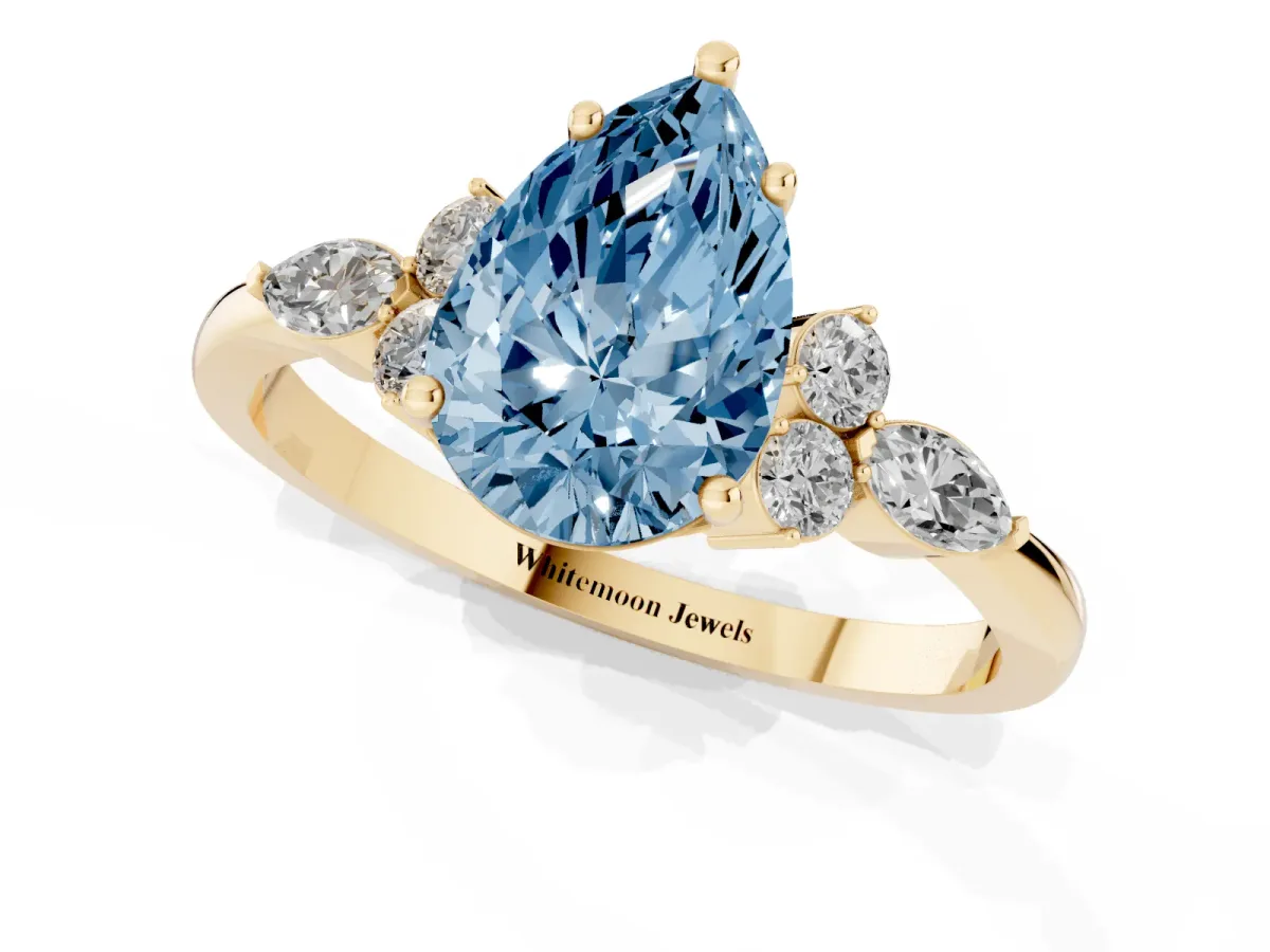 Fancy Blue Pear Cut Brilliant Diamond Solitaire Ring with Pear Side Stones and Four-Prong Setting Yellow gold