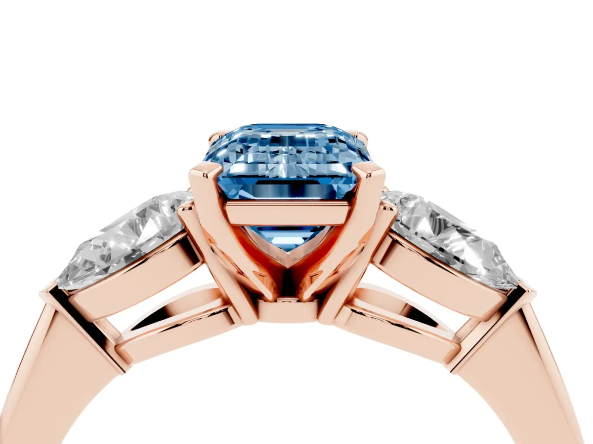 Fancy Blue Three-Stone Emerald Cut Diamond Ring with Pear Side Stones and Four-Prong Setting Rose gold