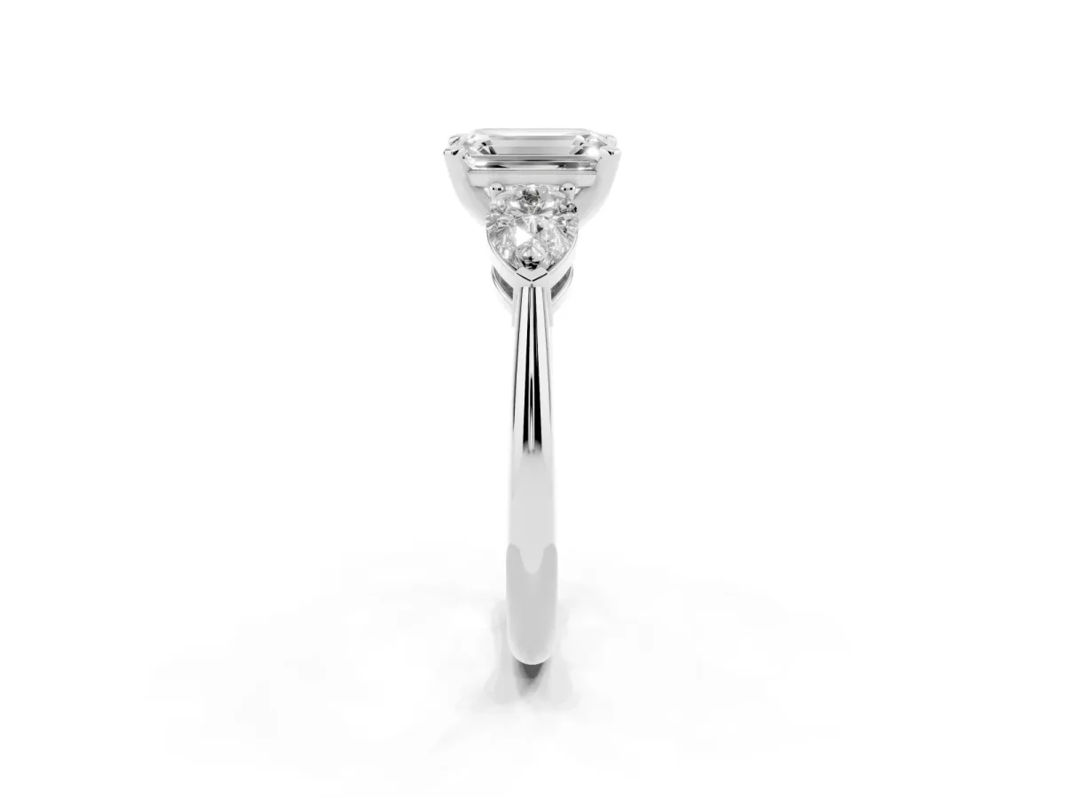 Three-Stone Emerald Cut Diamond Ring with Pear Side Stones and Four-Prong Setting Platinum