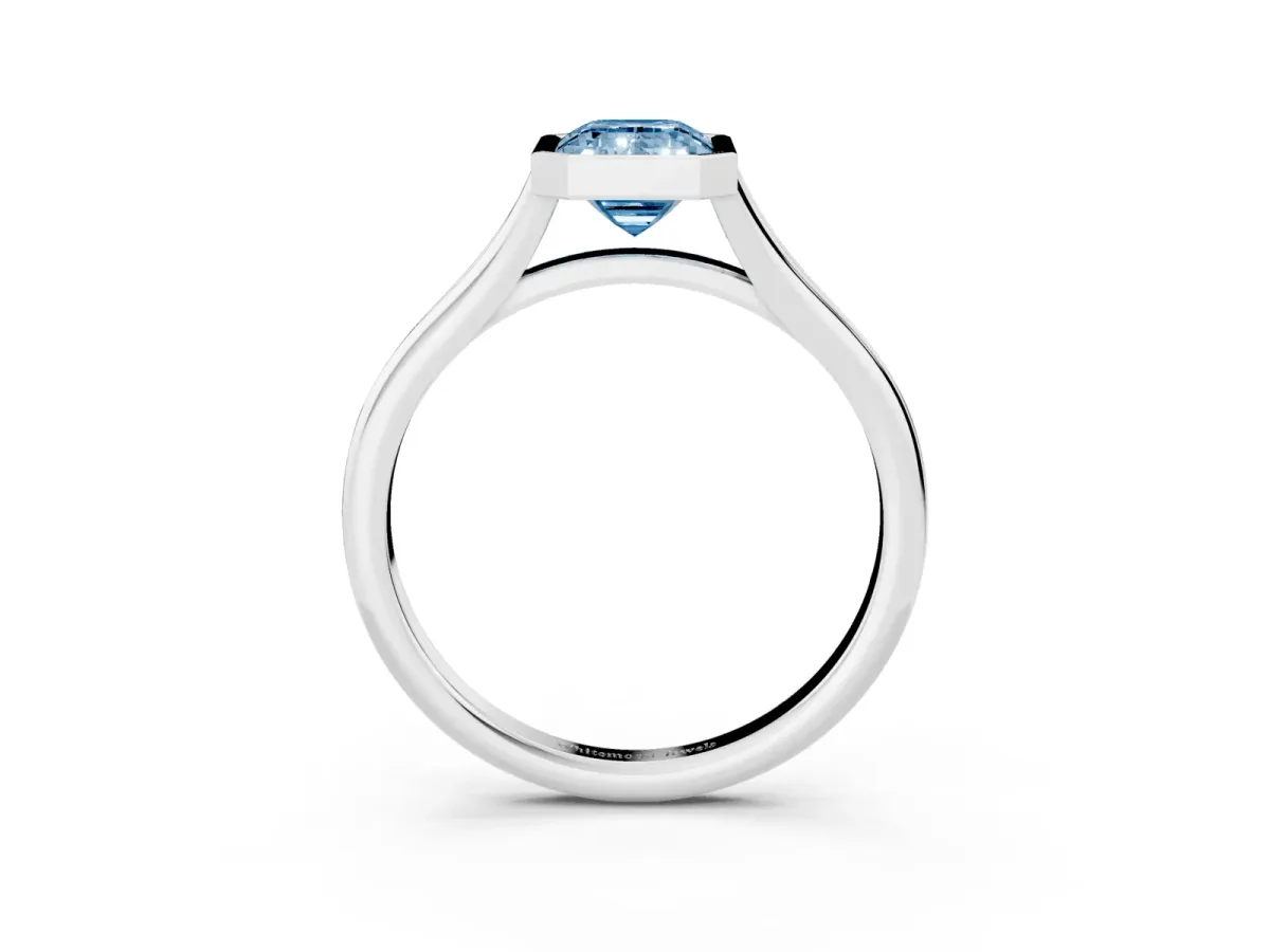 Fancy Blue Bezel Set Emerald Cut Cut Solitaire Ring with Tapered Band Silver