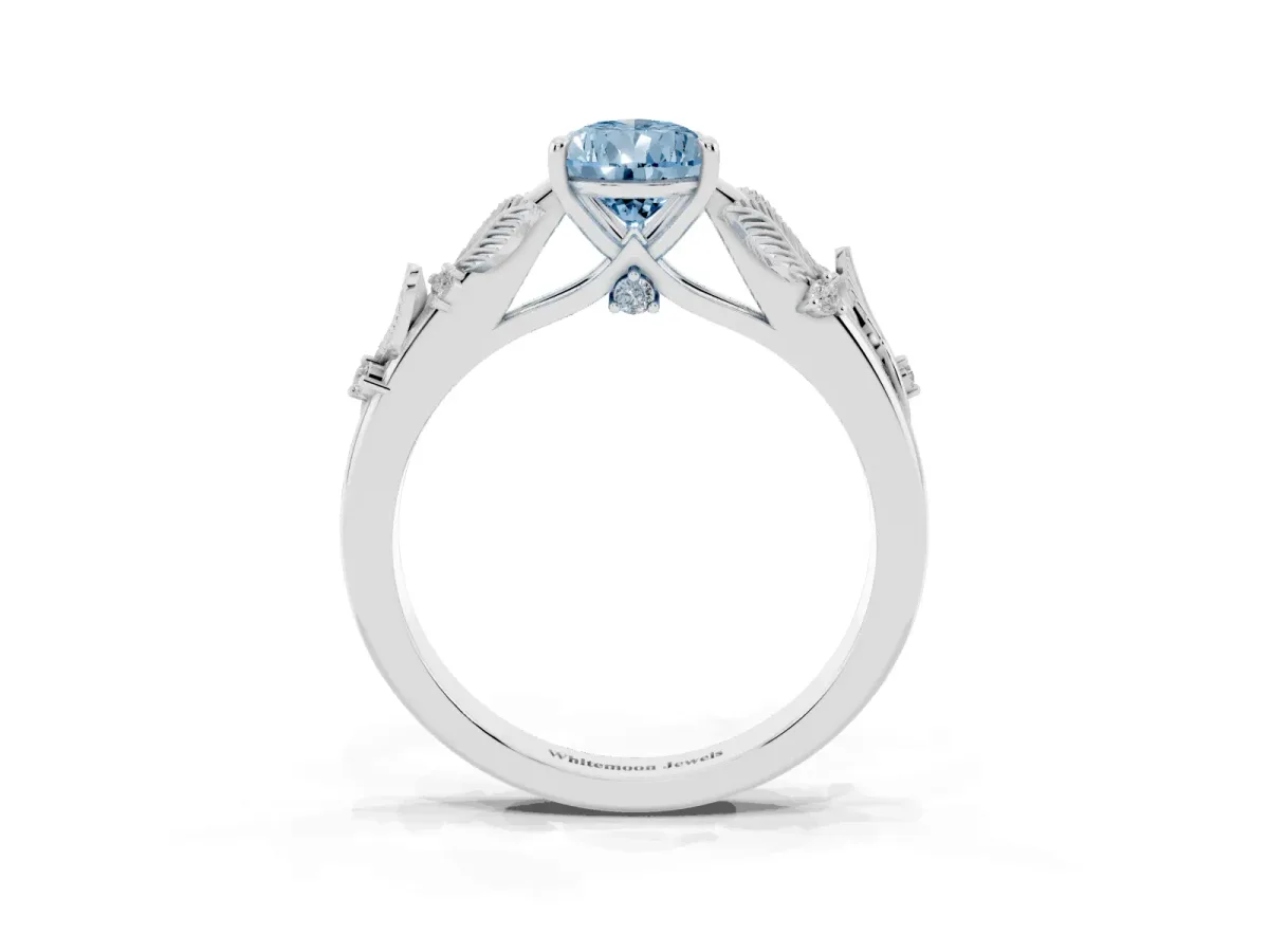 Fancy Blue Pear Cut Diamond Solitaire Ring with Leaf Motif Band and Four-Prong Setting Silver