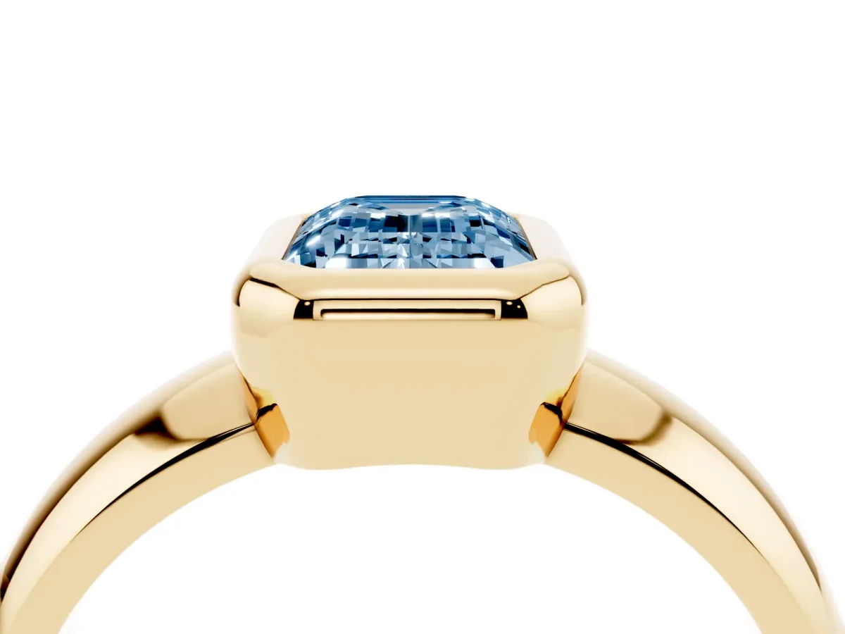 Fancy Blue Bezel Set Emerald Cut Solitaire Ring with Wide Band Yellow gold